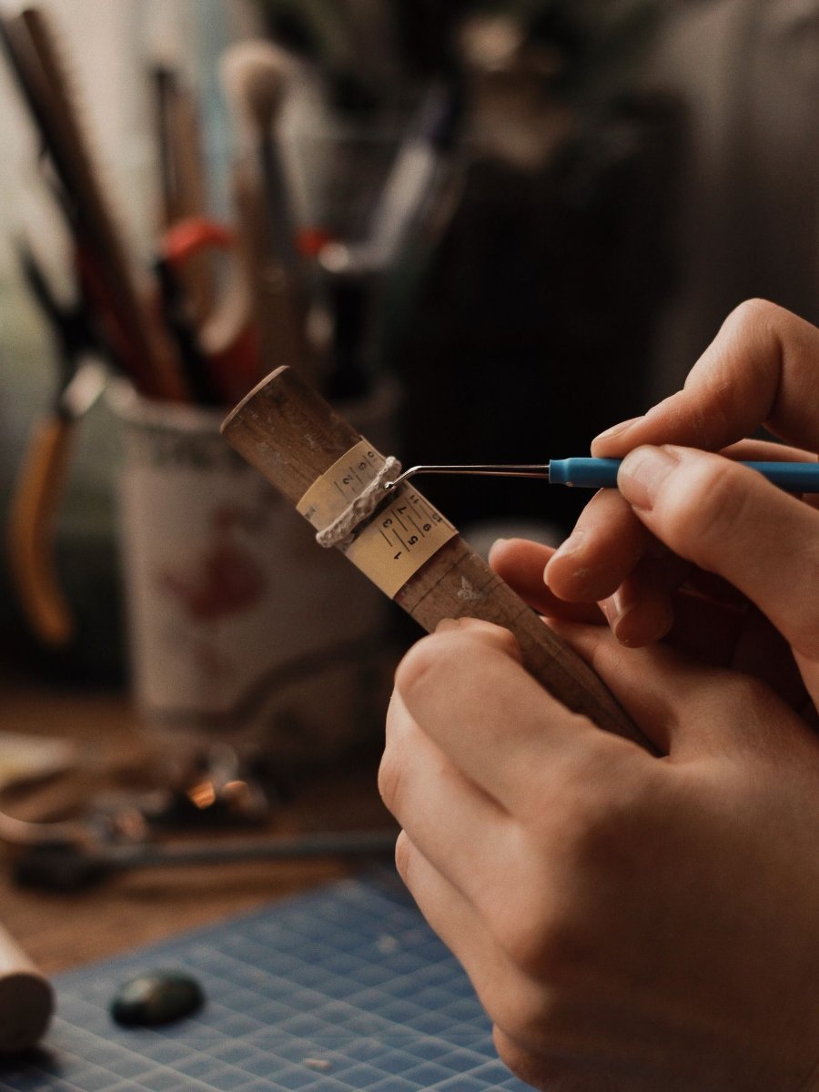 Hands working on a small piece at a jewelers bench