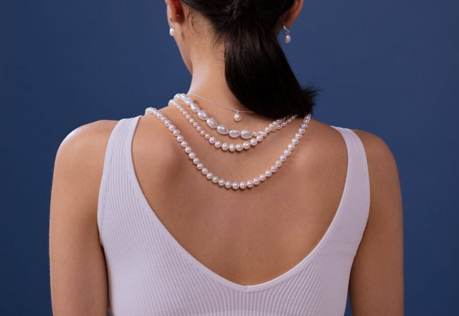 Layered pearl necklaces worn seen from behind